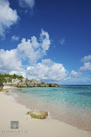 Sheltered Beach Under Summer Clouds
