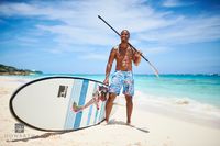 Paddleboarder with Board on Beach