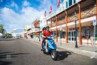 Scooter Riders in a Historic Town