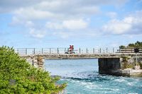 Scooter Rider on Coastal Bridge