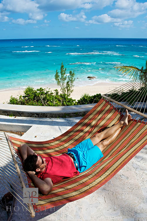 Watching the waves roll in while relaxing in a hammock above a private south shore beach, lounging in a pair of bright blue Bermuda...