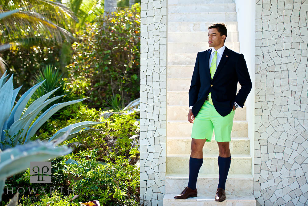 Portrait of a young professional wearing bright green Bermuda Shorts, with a matching tie and jacket.