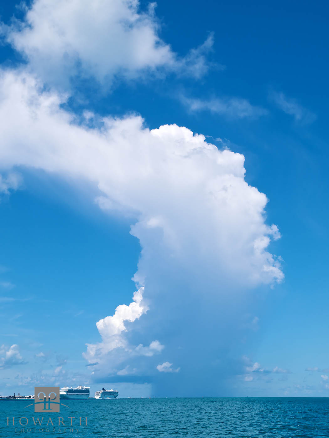 A towering cloud formation builds to the West near Dockyard with a cruise ship in port