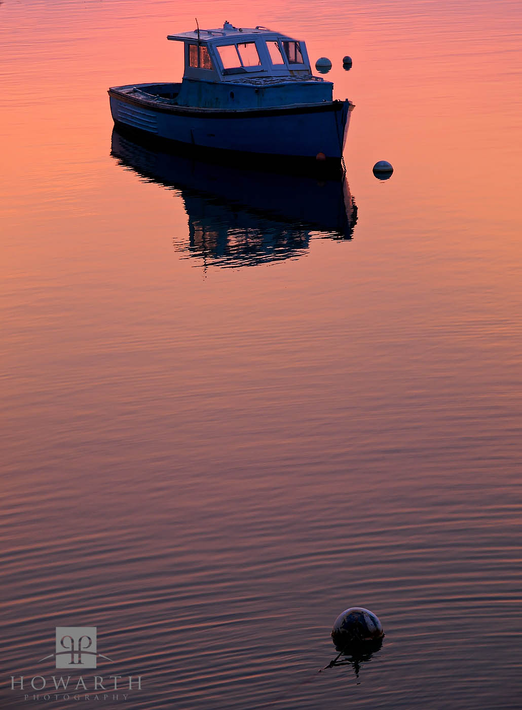 An older Bermudian boat moored up at sunset