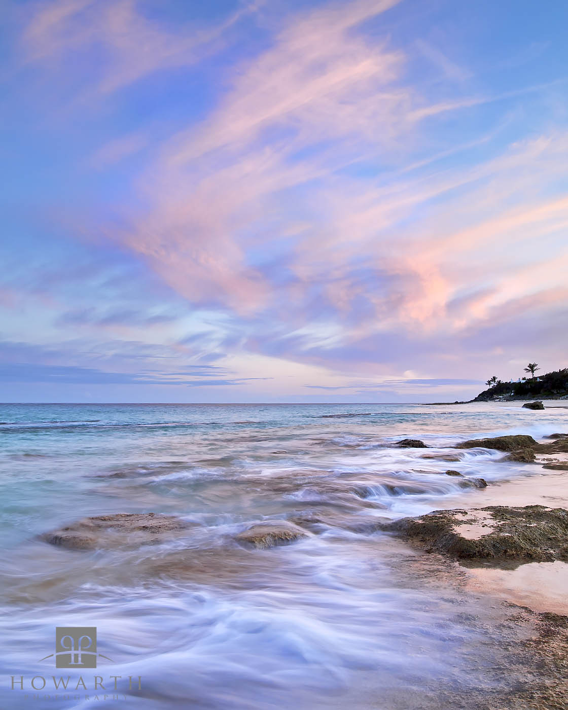 An evening scene at Grape Bay with a pink and blue sky