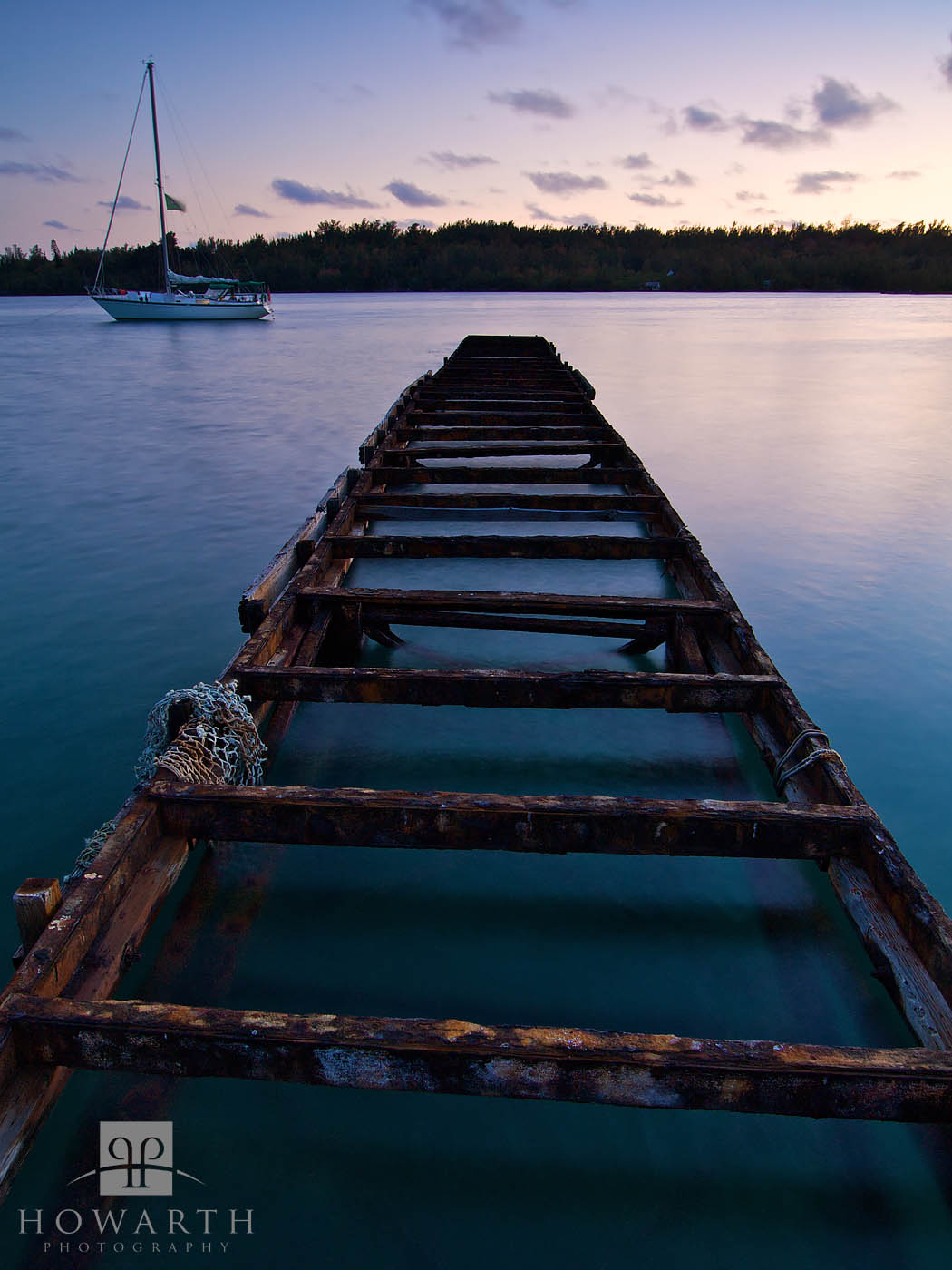 Twighlight image of the old reminants of a dock and sailboat