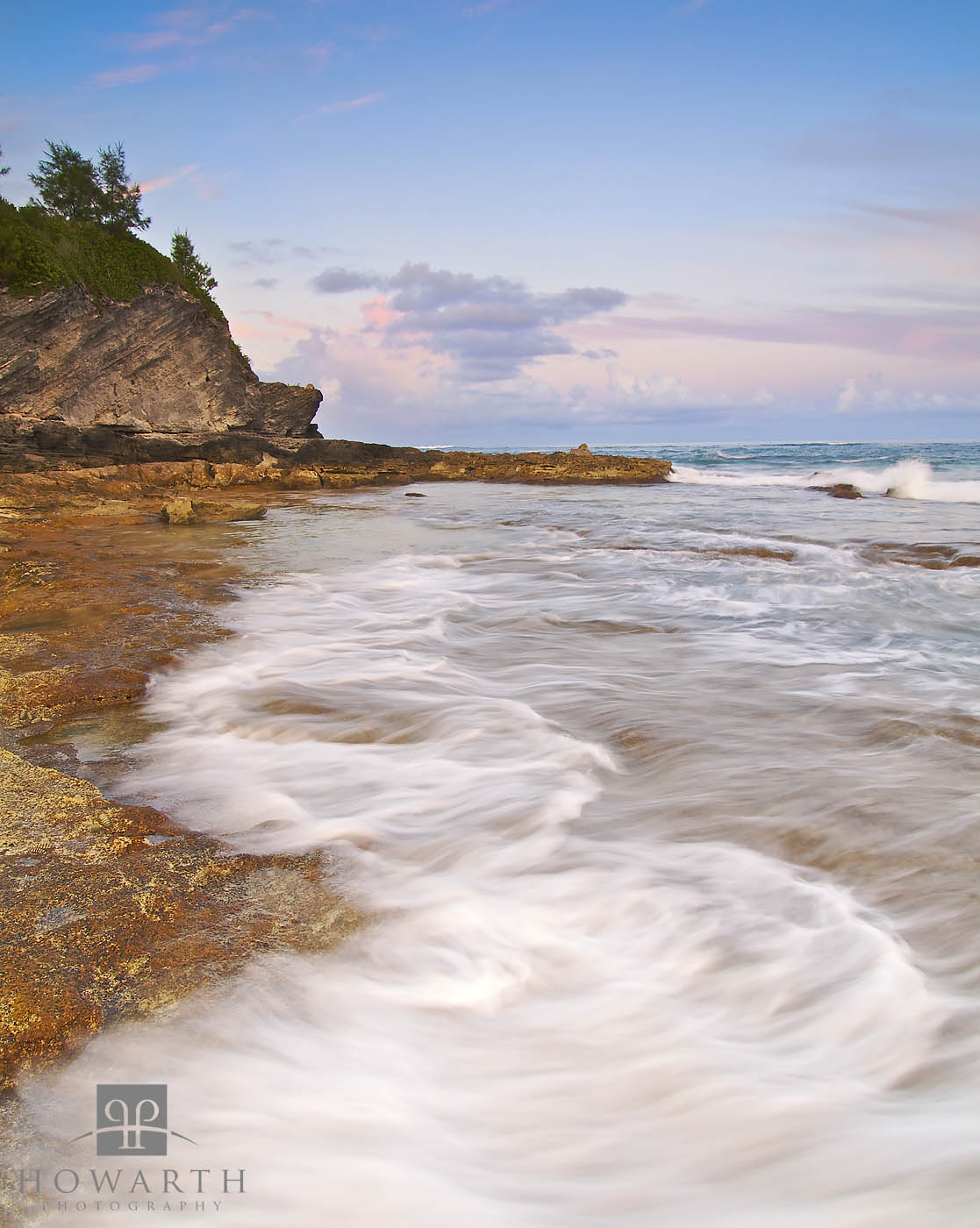Incoming waves wash ashore on the rocky coastline of Devonshire Bay