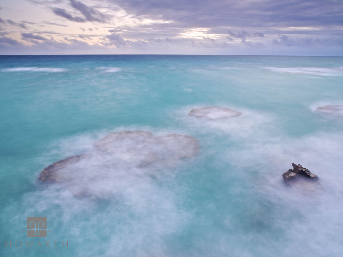 A long exposure smoothes the turbulent water covering the reef